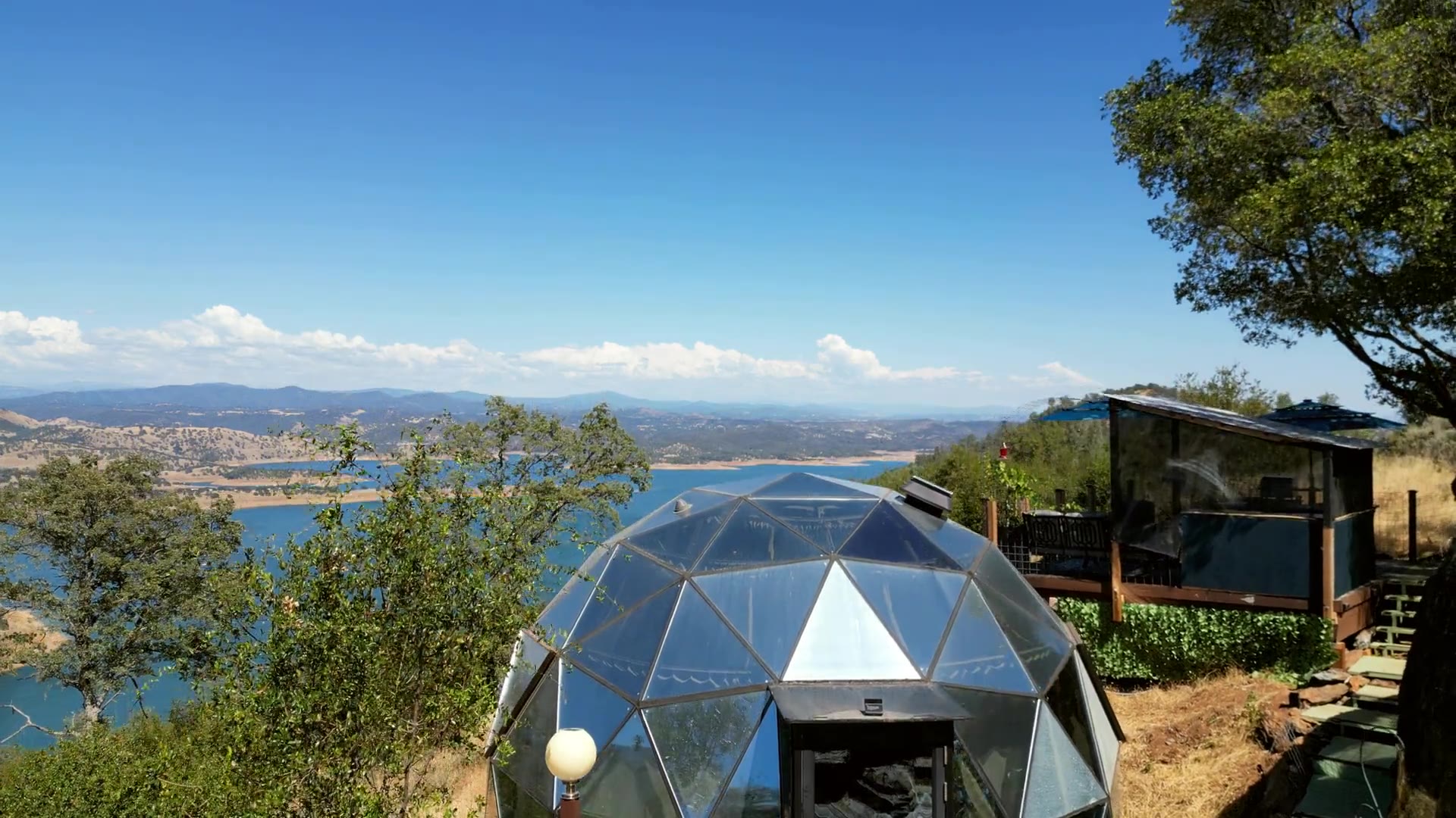 The Glashaus glass dome on its ridge above New Melones Lake