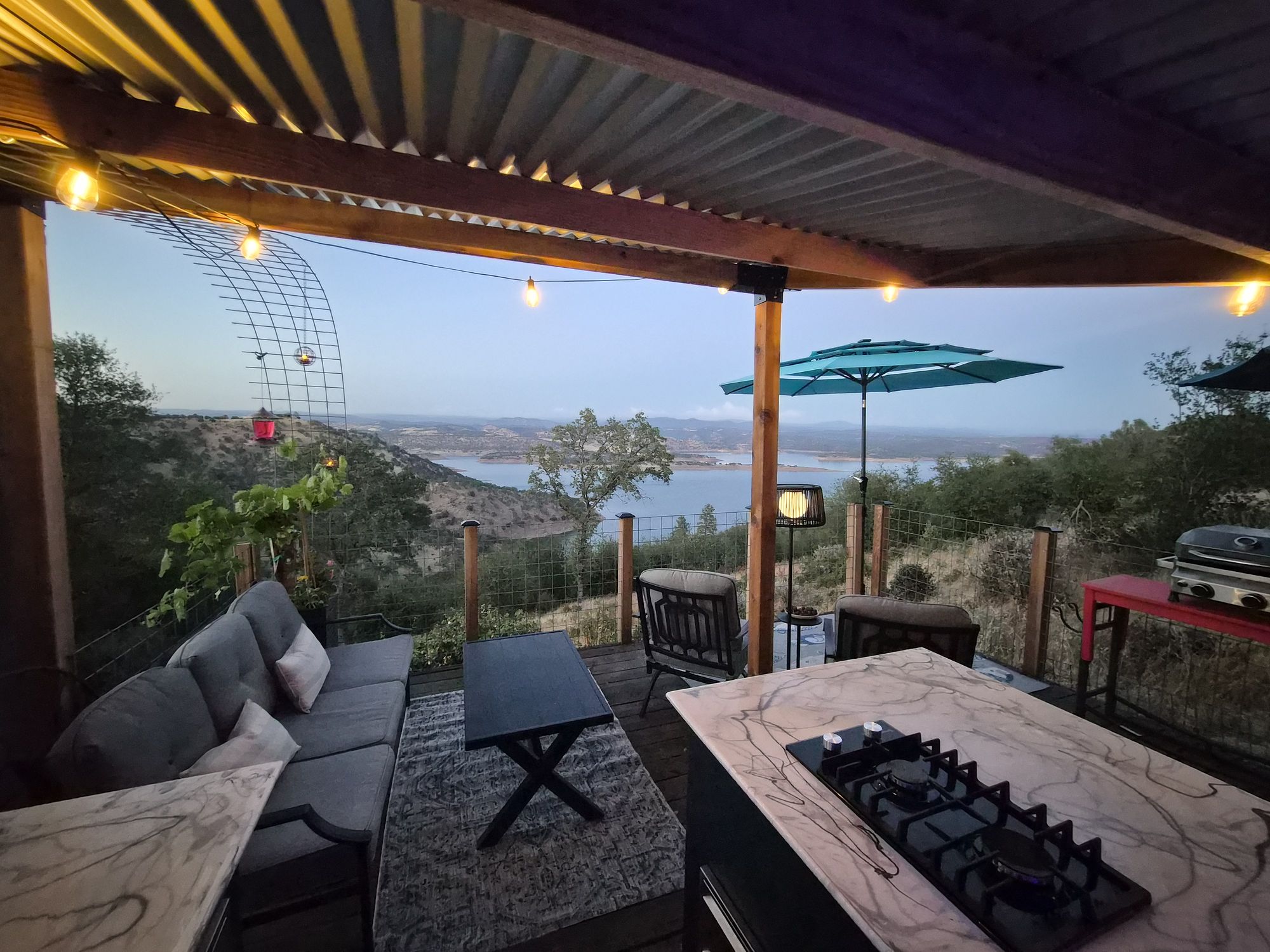 The Perch under the pergola at dusk, lake beyond