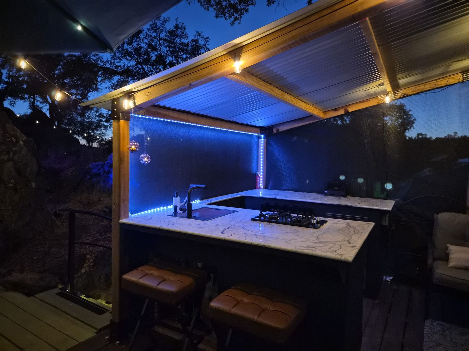 The outdoor kitchen lit at night